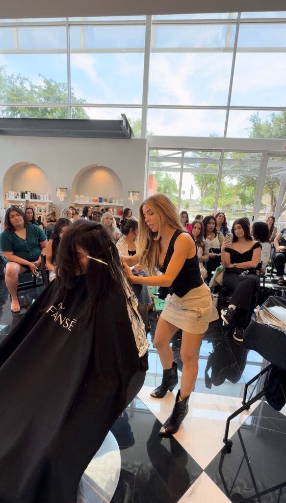 hair stylist apply color on woman's hir